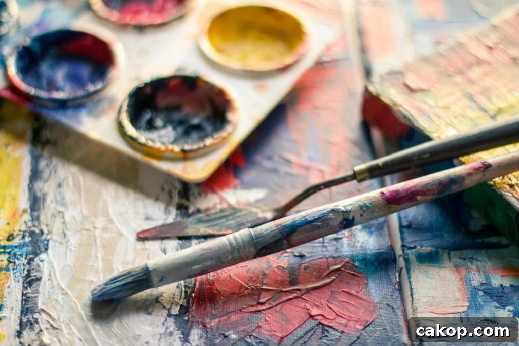 15 Fun Hobbies to Do With Your Kids for Quality Family Time 2 paintbrushes and paint on wooden table
