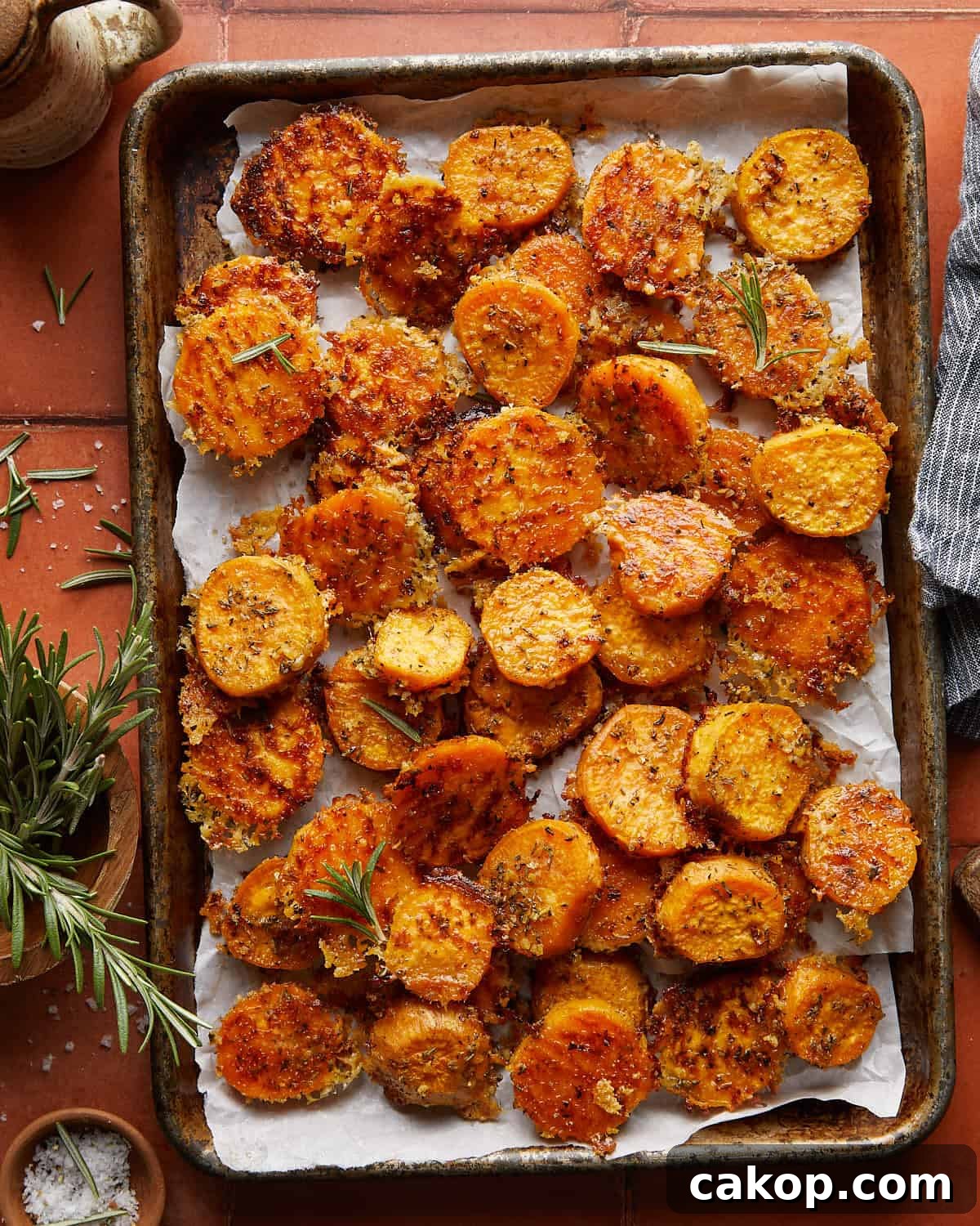 Overhead image of savory roasted sweet potatoes with garnish. 