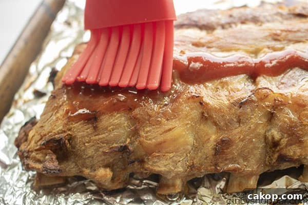 BBQ sauce added to slow cooked ribs