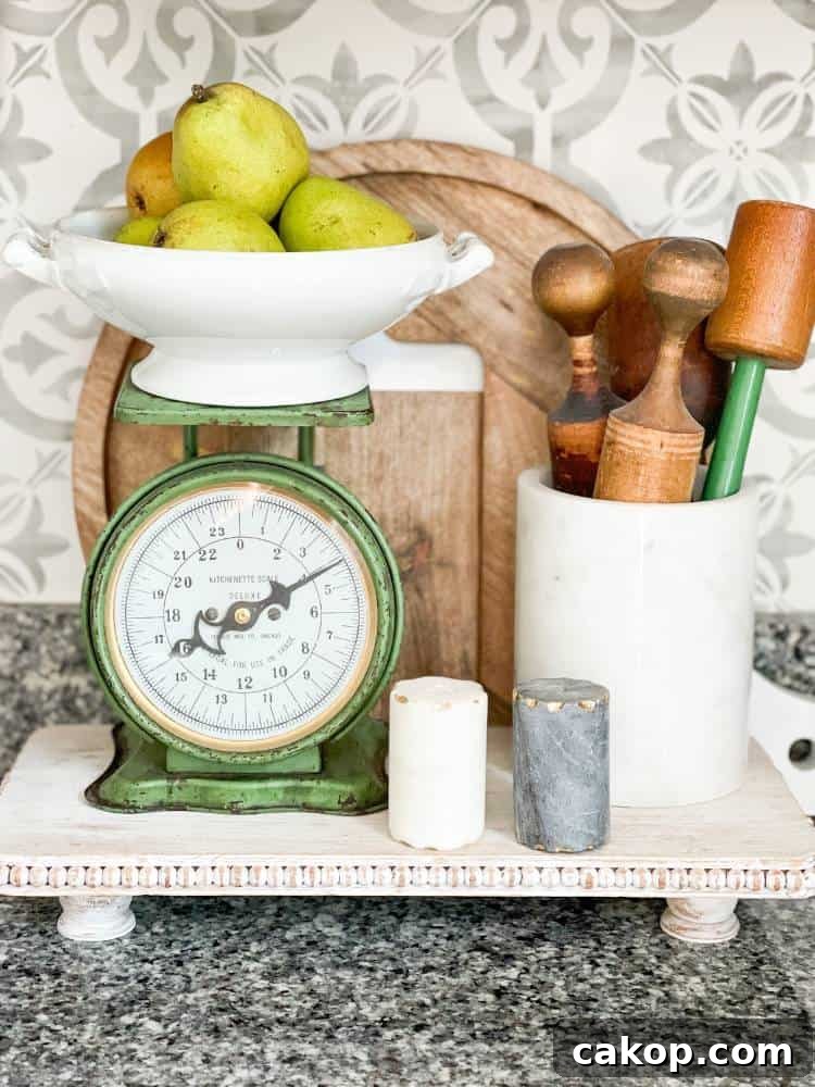 green vintage scale and kitchen supplies on wood riser on counter