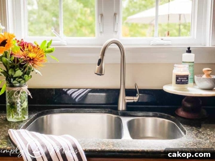 view of kitchen sink with window above and flowers next to sink