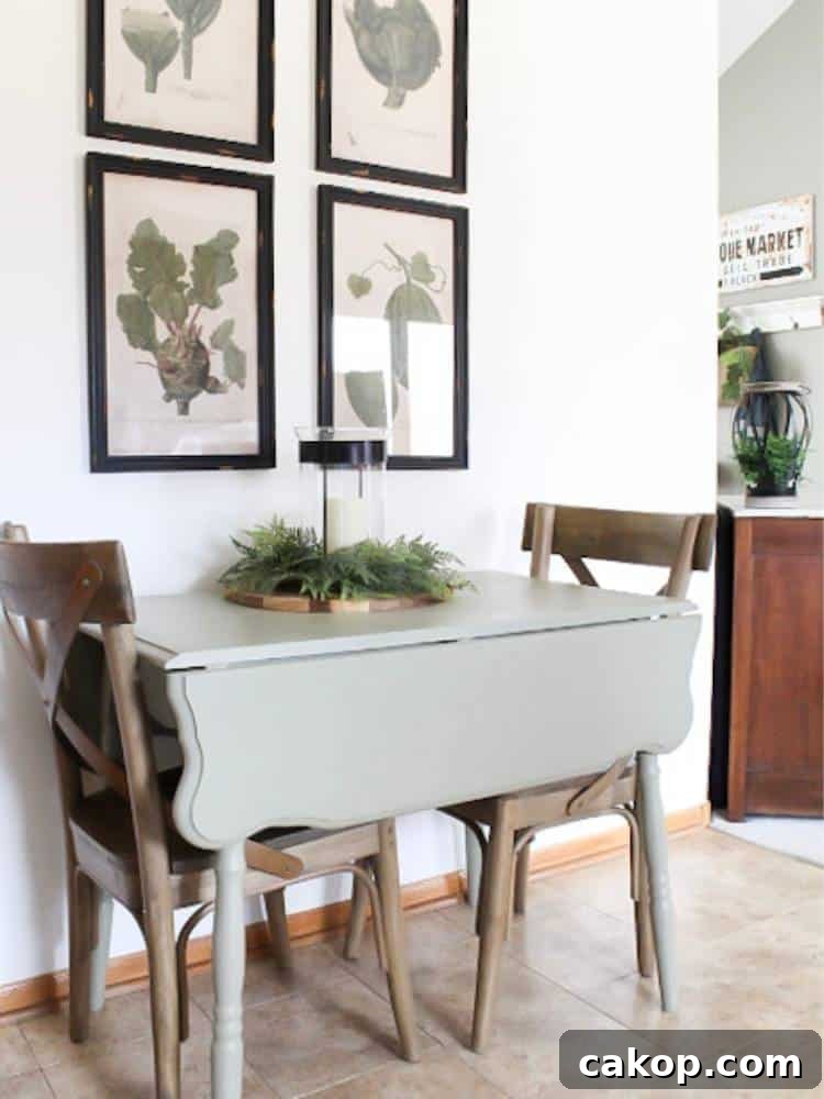 painted drop leaf table with two chairs set of four botanical prints above