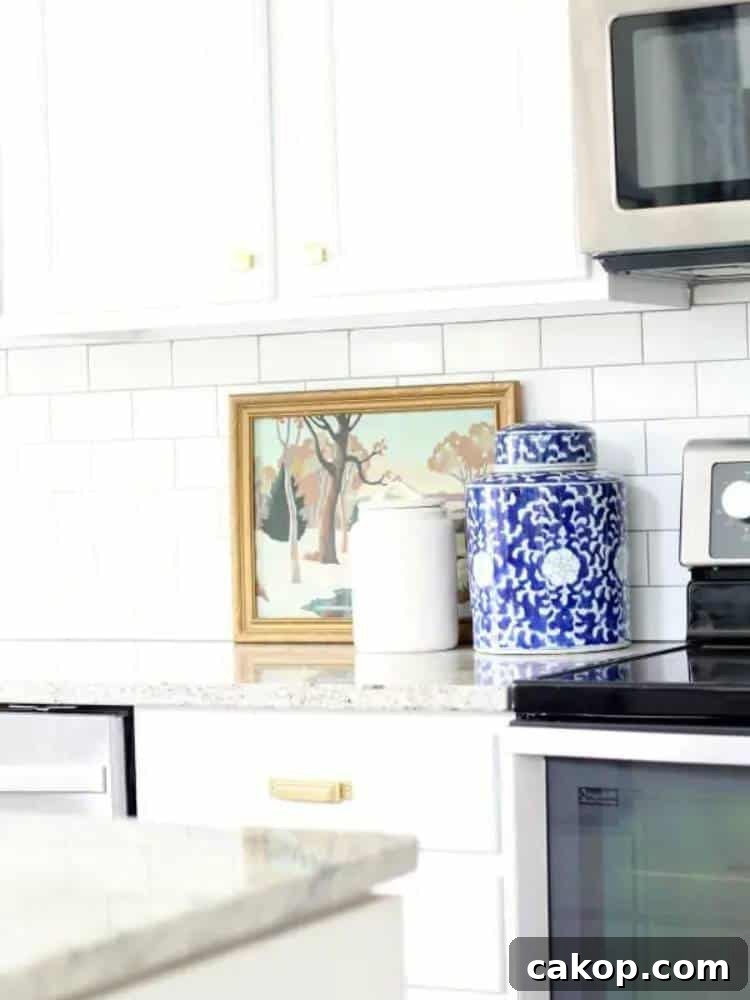 white kitchen cabinets with blue and white jar