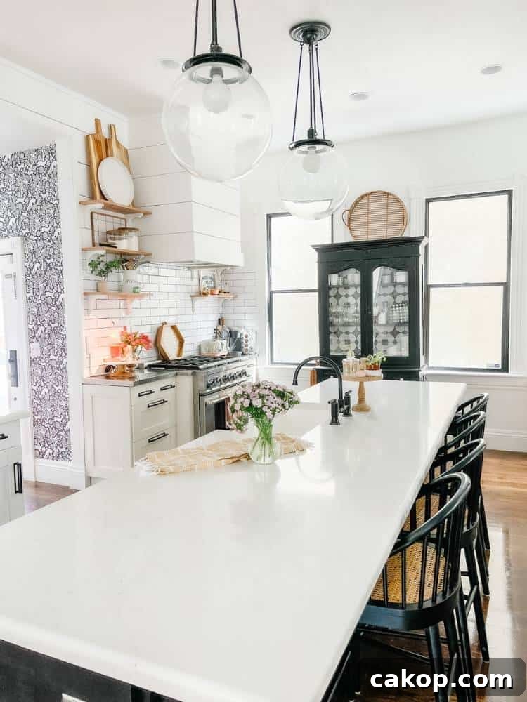 kitchen island with white counters black hutch by window