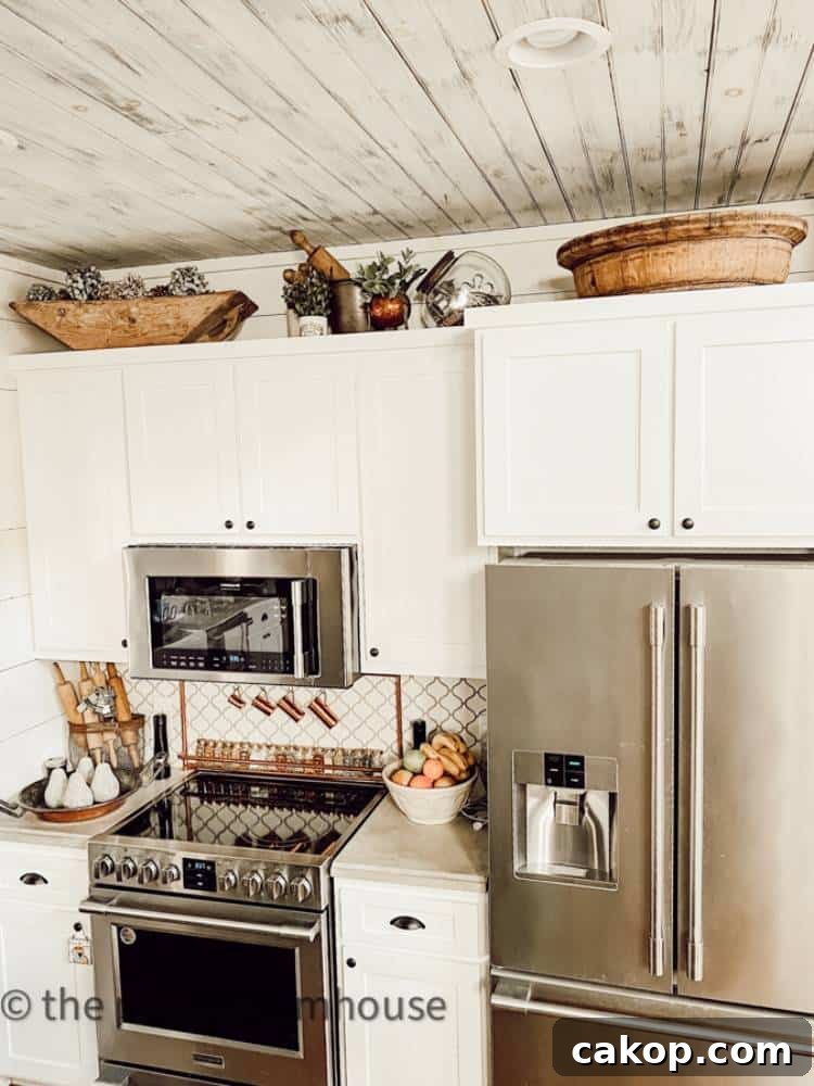 white cabinets with stainless appliances and vintage wood bowls on top of cabinets