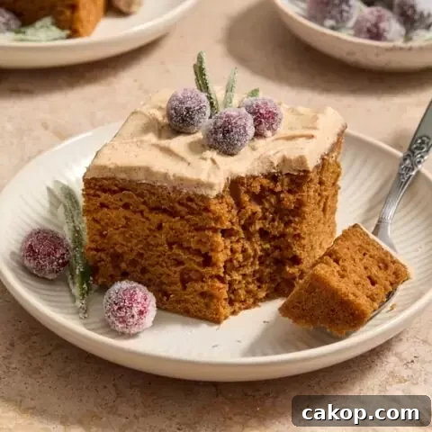 A piece of Dairy Free Gingerbread Cake with a bite taken with a fork.