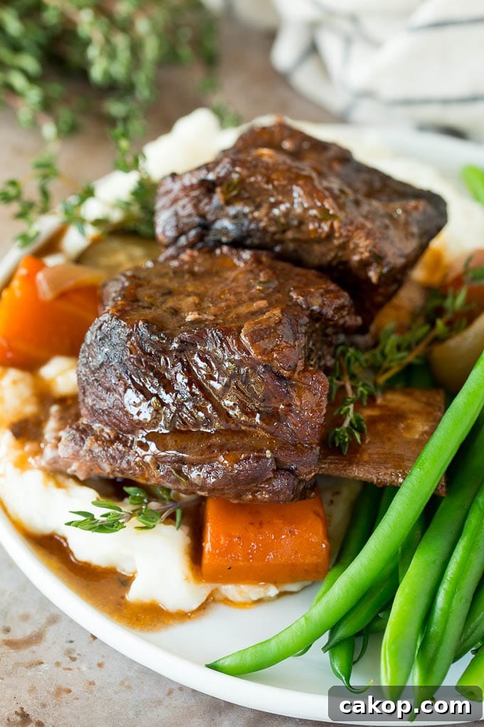 Tender Slow Cooker Short Ribs Recipe for Melt-in-Your-Mouth Beef 6 Slow cooker short ribs served with mashed potatoes and green beans.