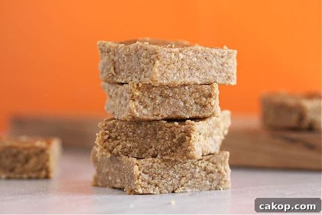 Almond butter bars with an orange background.