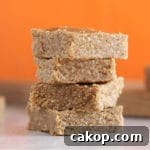 Almond butter bars with an orange background.