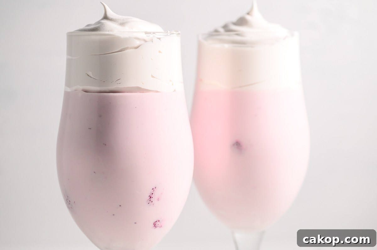 3 Ingredient Strawberry Fluff in 2 tall dessert glasses.
