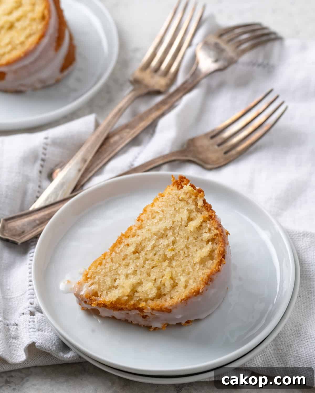 A slice of gluten free lemon pound cake served on a white plate.