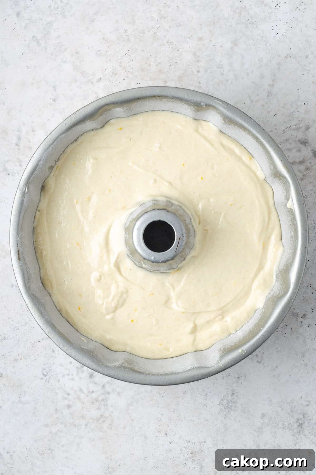 Unbaked lemon pound cake batter in a bundt pan. 