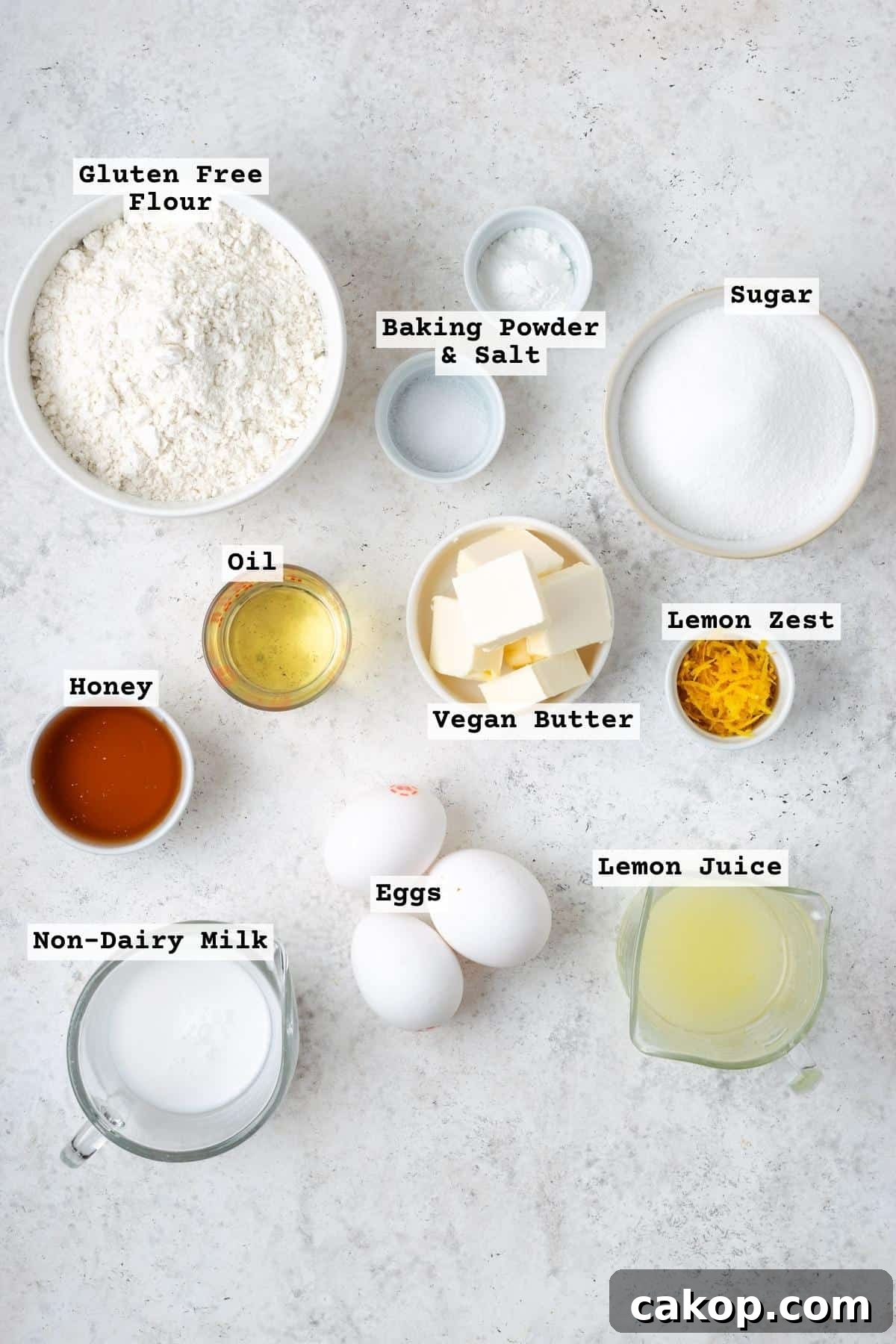 Ingredients for a lemon pound cake on a white table.
