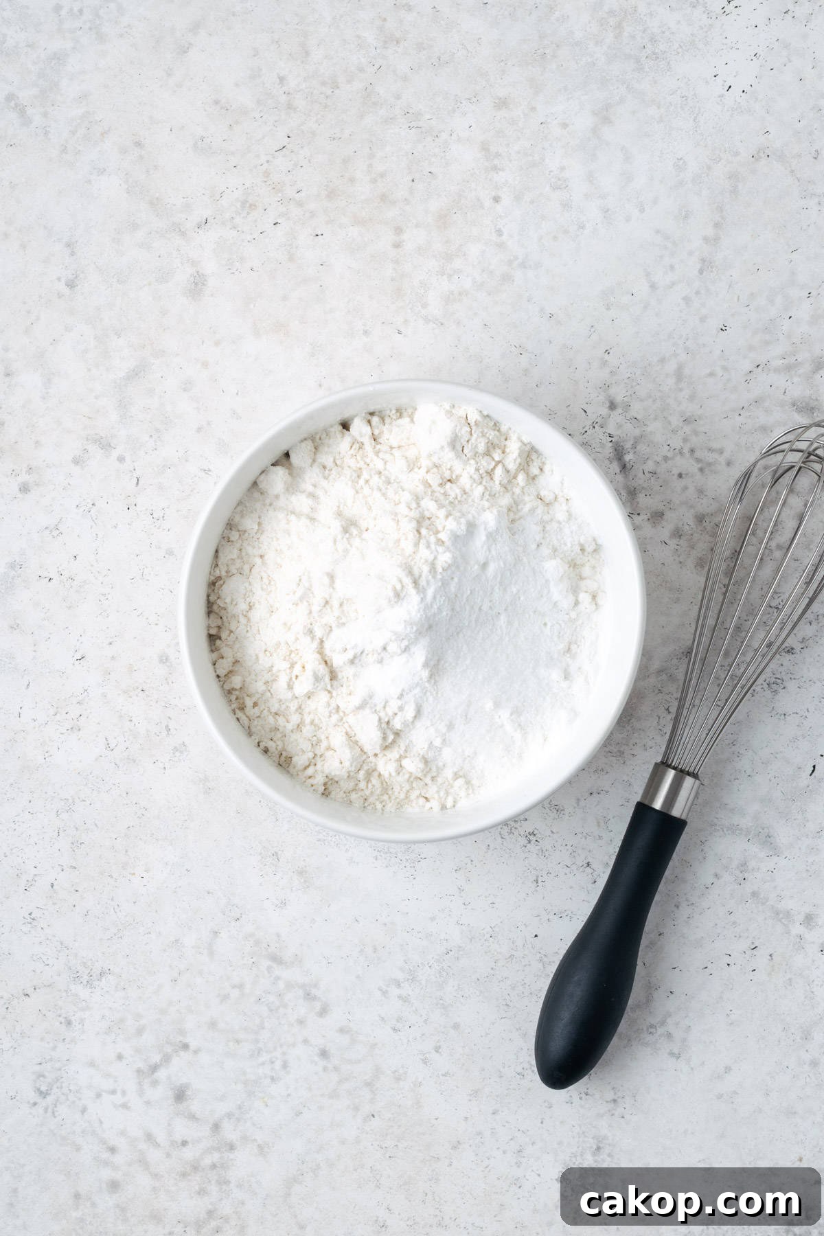 Gluten free flour, baking powder and salt in a small white bowl.