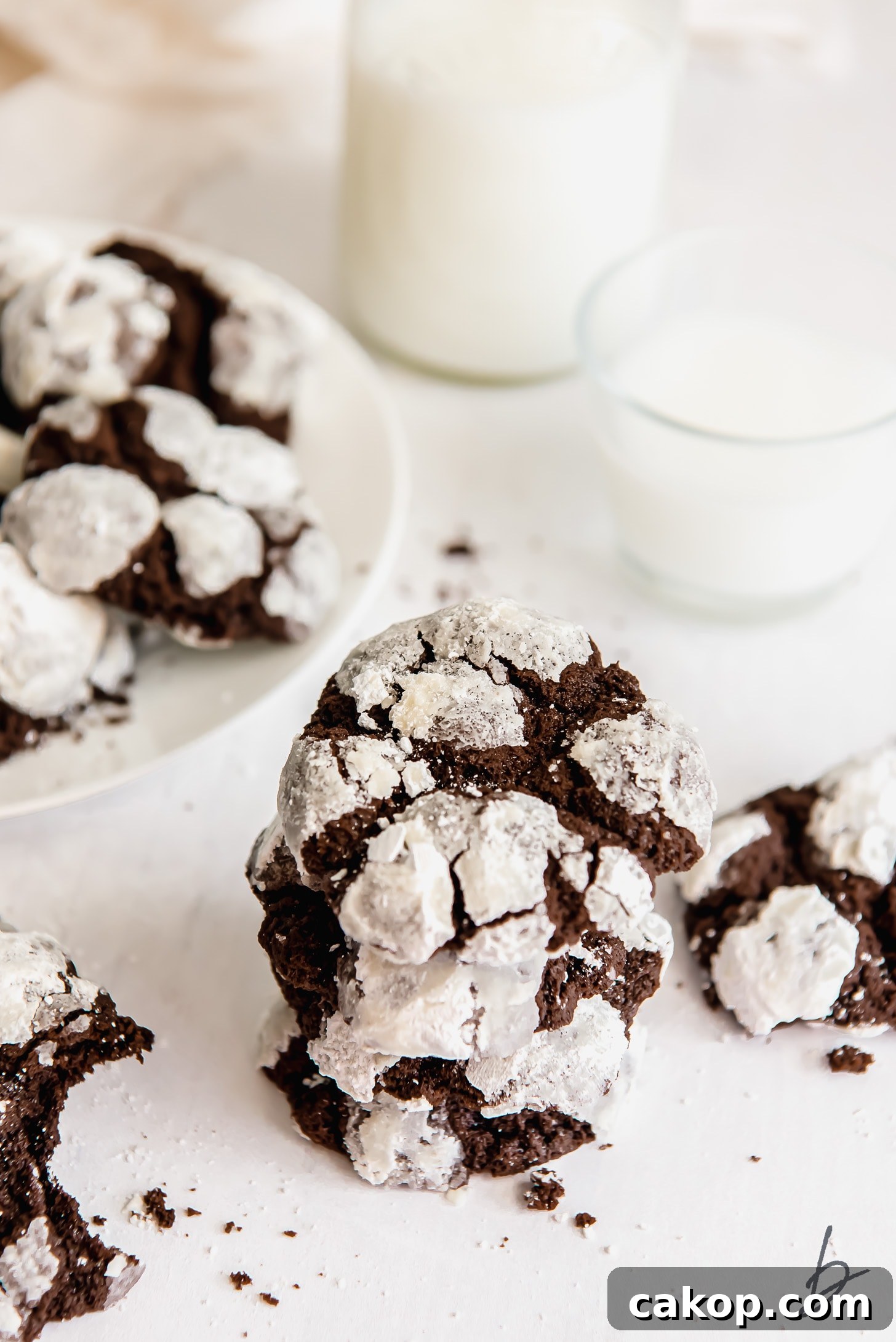 Chewy Chocolate Crinkle Cookie Recipe 7 stack of chocolate crinkle cookies covered in powdered sugar