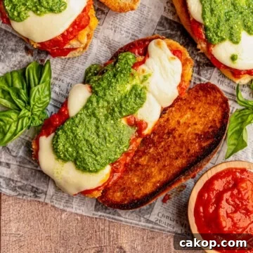 Chicken parmesan sandwich topped with pesto.