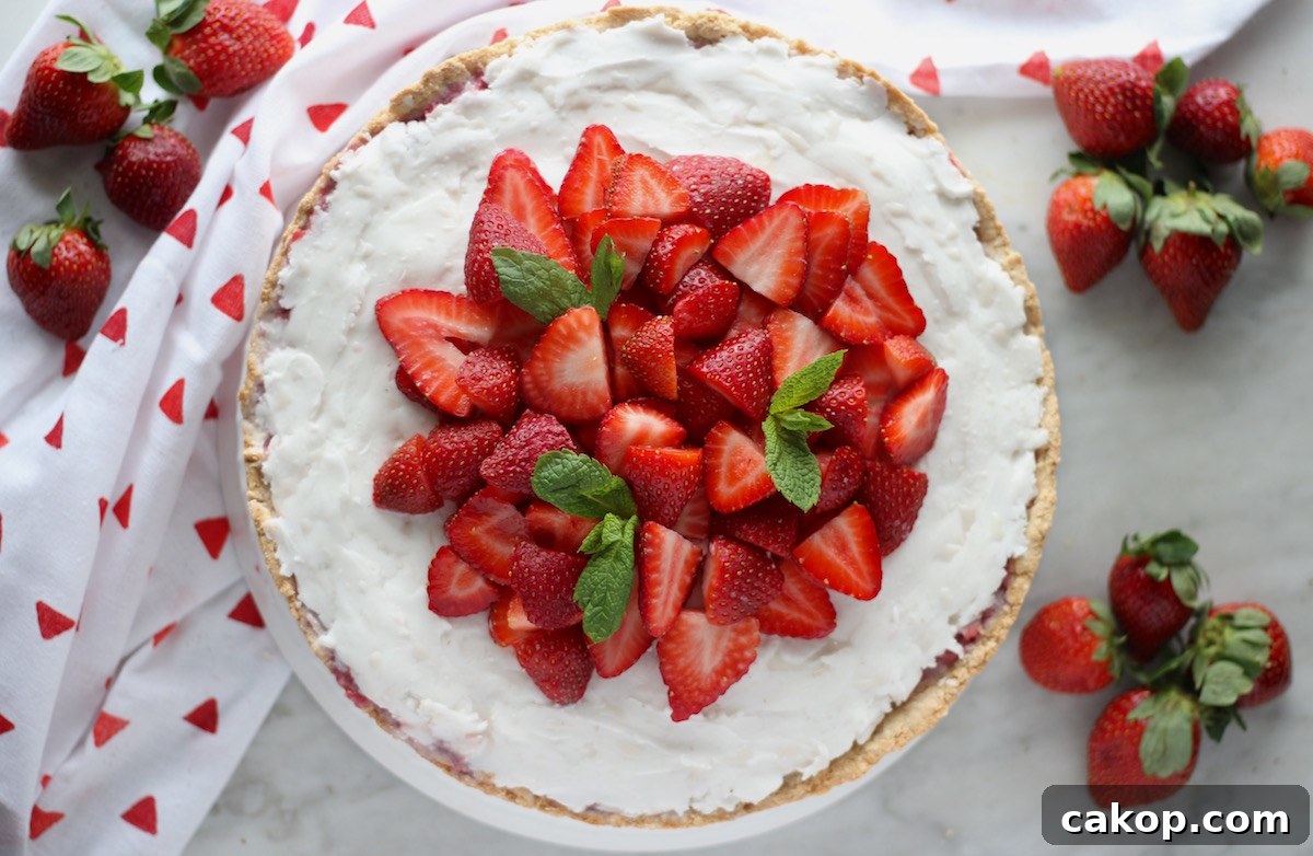 Paleo Strawberries and Cream Tart (AIP, Vegan) - a show-stopping strawberry tart made with fresh berries, whipped coconut cream, and a crispy coconut cookie crust! YUM! | fedandfulfilled.com
