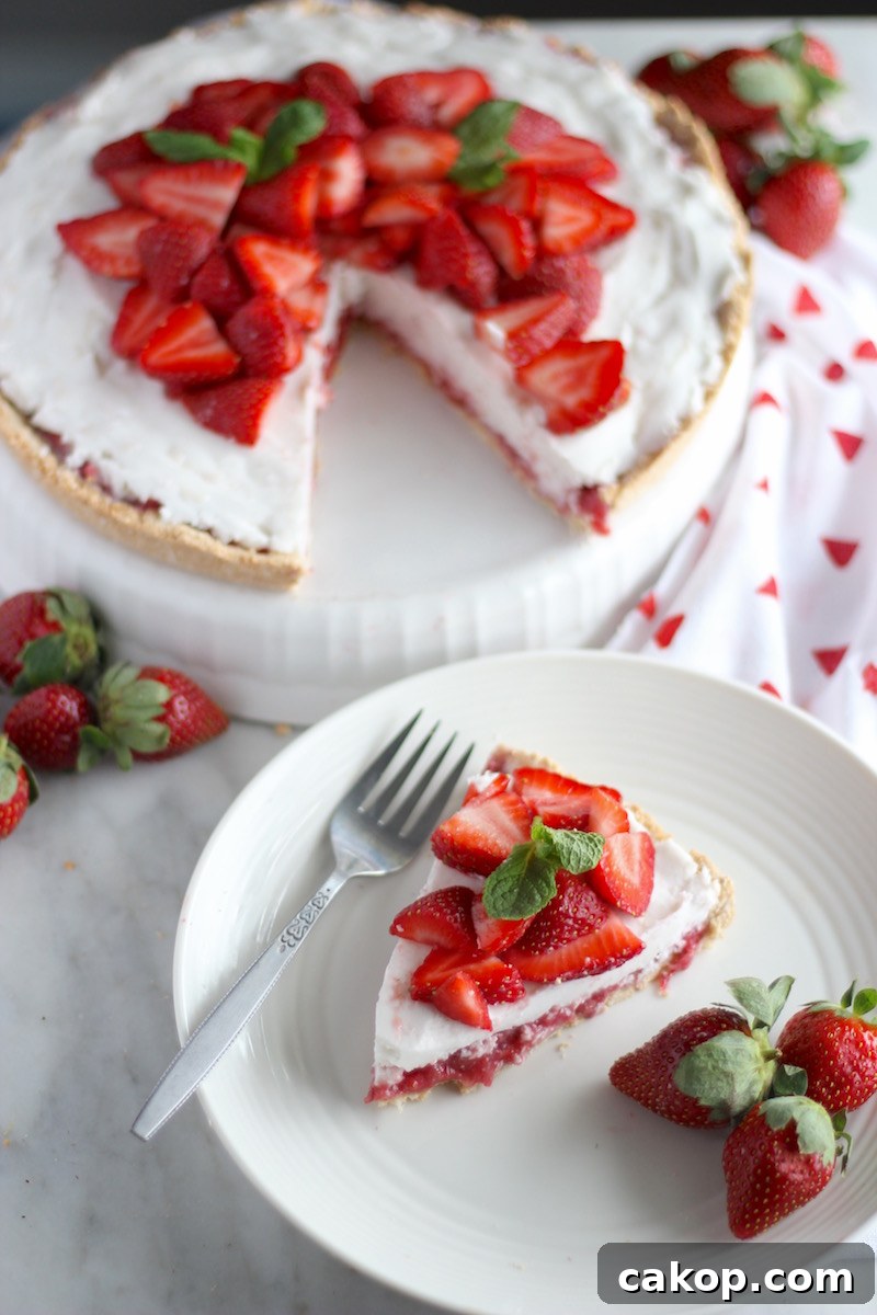 Paleo Strawberries and Cream Tart (AIP, Vegan) - a luscious fresh strawberry tart is topped with thick coconut cream and encased in a coconut cookie crust! Heavenly! | fedandfulfilled.com