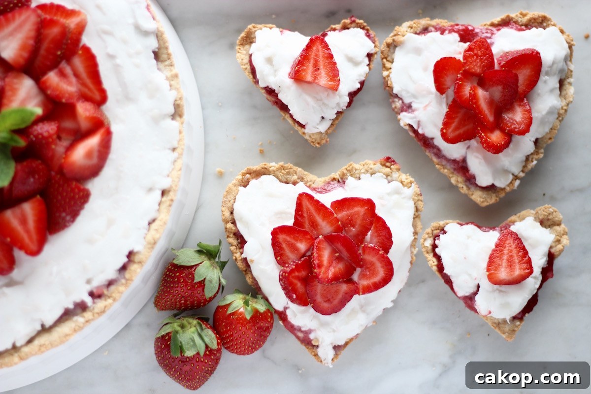 Paleo Strawberries and Cream Tart (AIP, Vegan) - a beautiful fresh strawberry dessert featuring juicy berries, a sweet dairy-free coconut filling, and a crispy coconut cookie crust! | fedandfulfilled.com