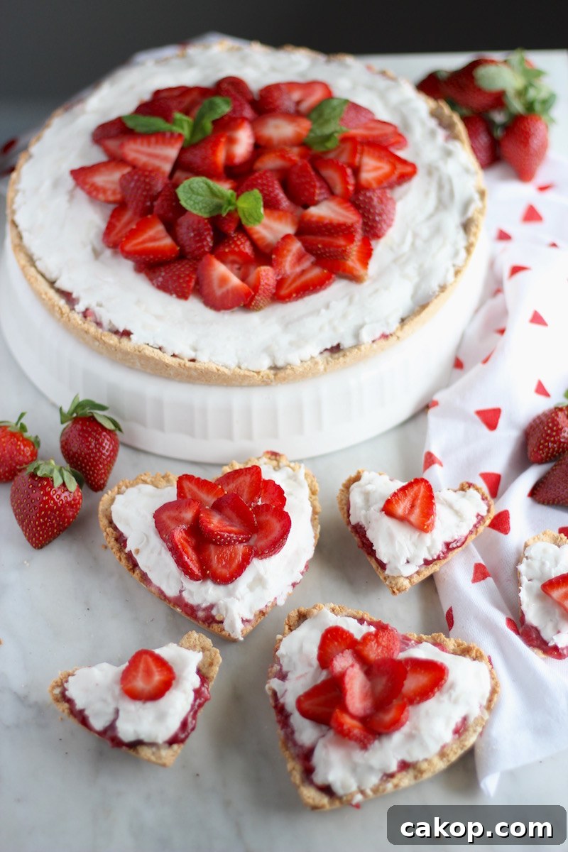 Paleo Strawberries and Cream Tart (AIP, Vegan) - a perfect dessert for a special occasion! Featuring a sweet strawberry and coconut cream filling, a coconut cookie crust, and a pile of juicy strawberries on top! | fedandfulfilled.com