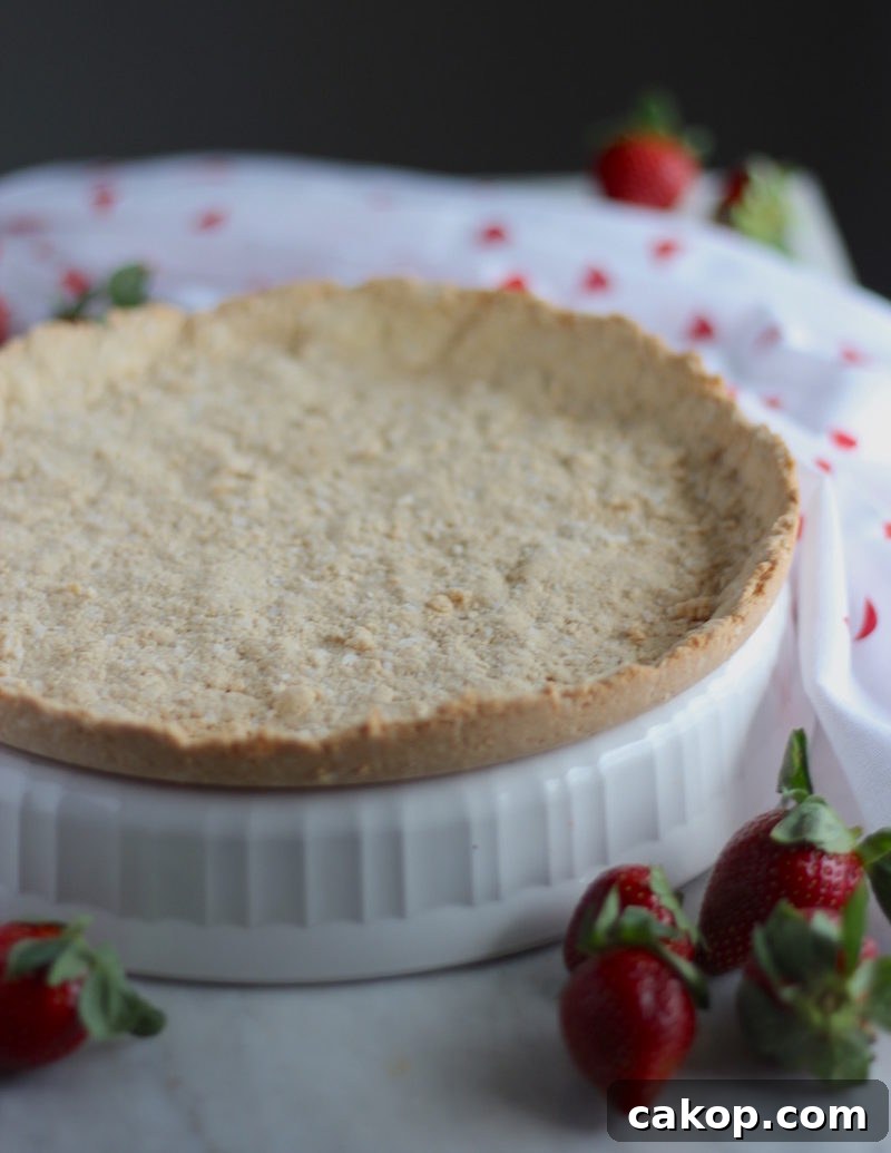 Paleo Strawberries and Cream Tart (AIP, Vegan) - a stunning dairy-free strawberry tart filled with juicy berries and thick coconut cream, all in a crispy coconut cookie crust! Delicious! | fedandfulfilled.com