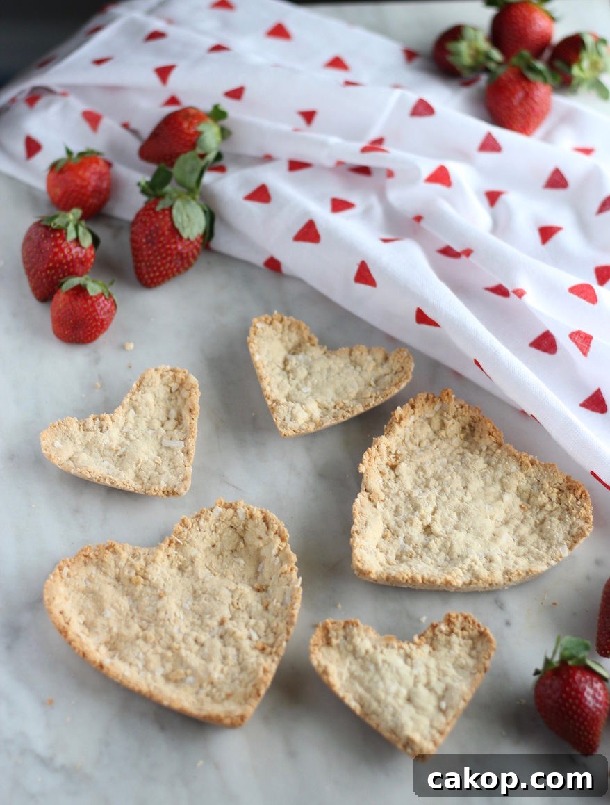 Paleo Strawberries and Cream Tart (AIP, Vegan) - a healthy and delicious fresh strawberry tart filled with a strawberry compote and a sweet coconut cream, in a coconut macaroon crust! | fedandfulfilled.com