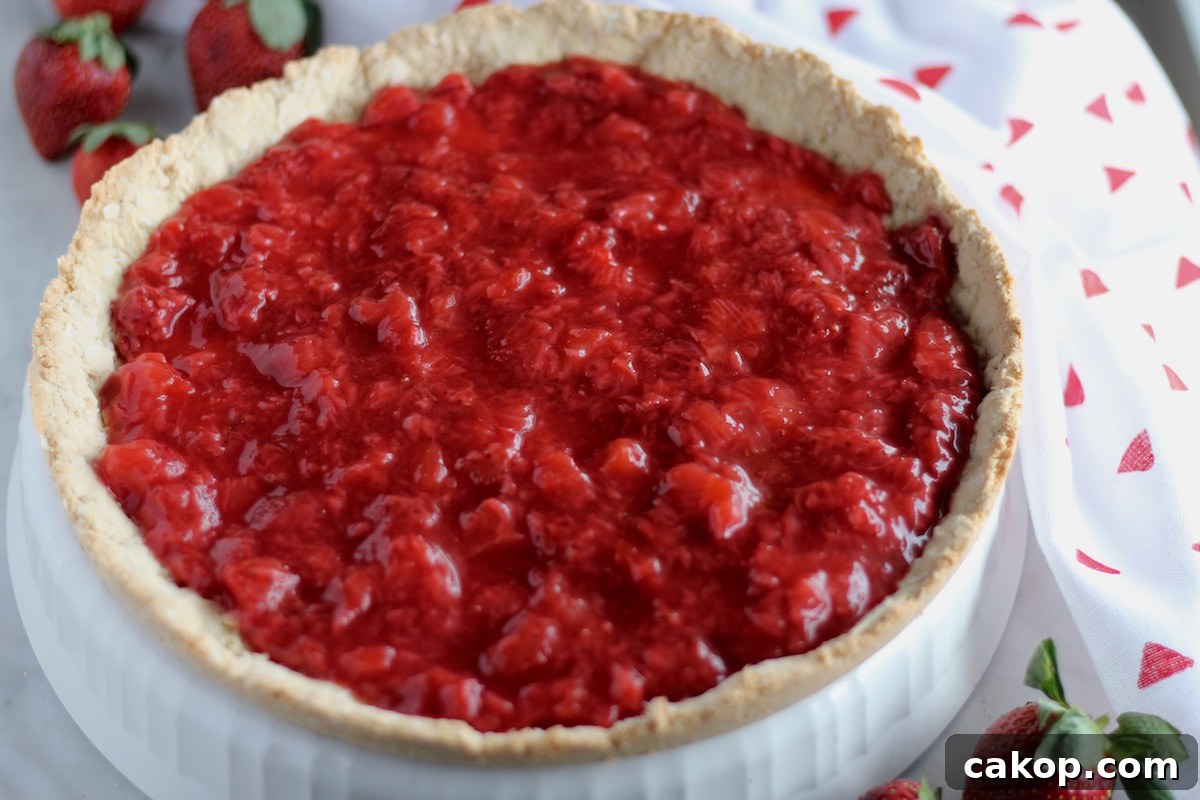Paleo Strawberries and Cream Tart (AIP) - a luscious fresh strawberry tart filled with homemade strawberry compote, whipped coconut cream, and a coconut cookie crust! SO good! | fedandfulfilled.com