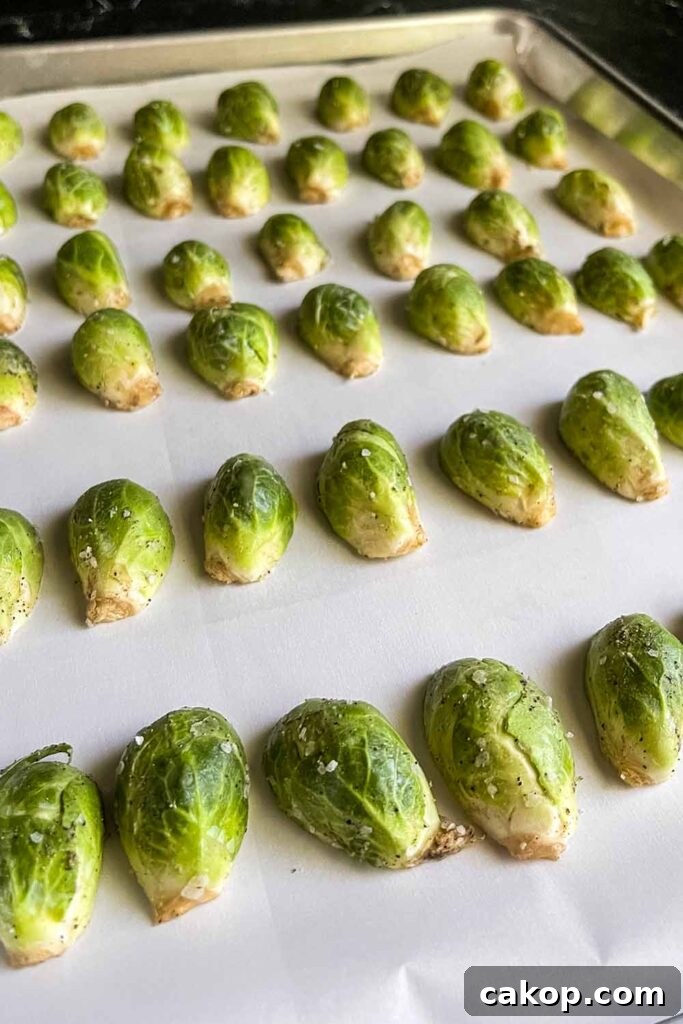 Roasted Brussels Sprouts with Bacon and Honey-Butter Glaze 5 Raw brussels sprouts on a baking sheet.