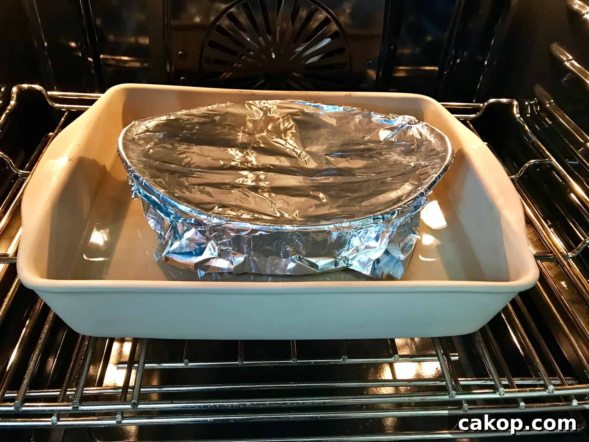 Pan covered in foil in pan full of water in oven 