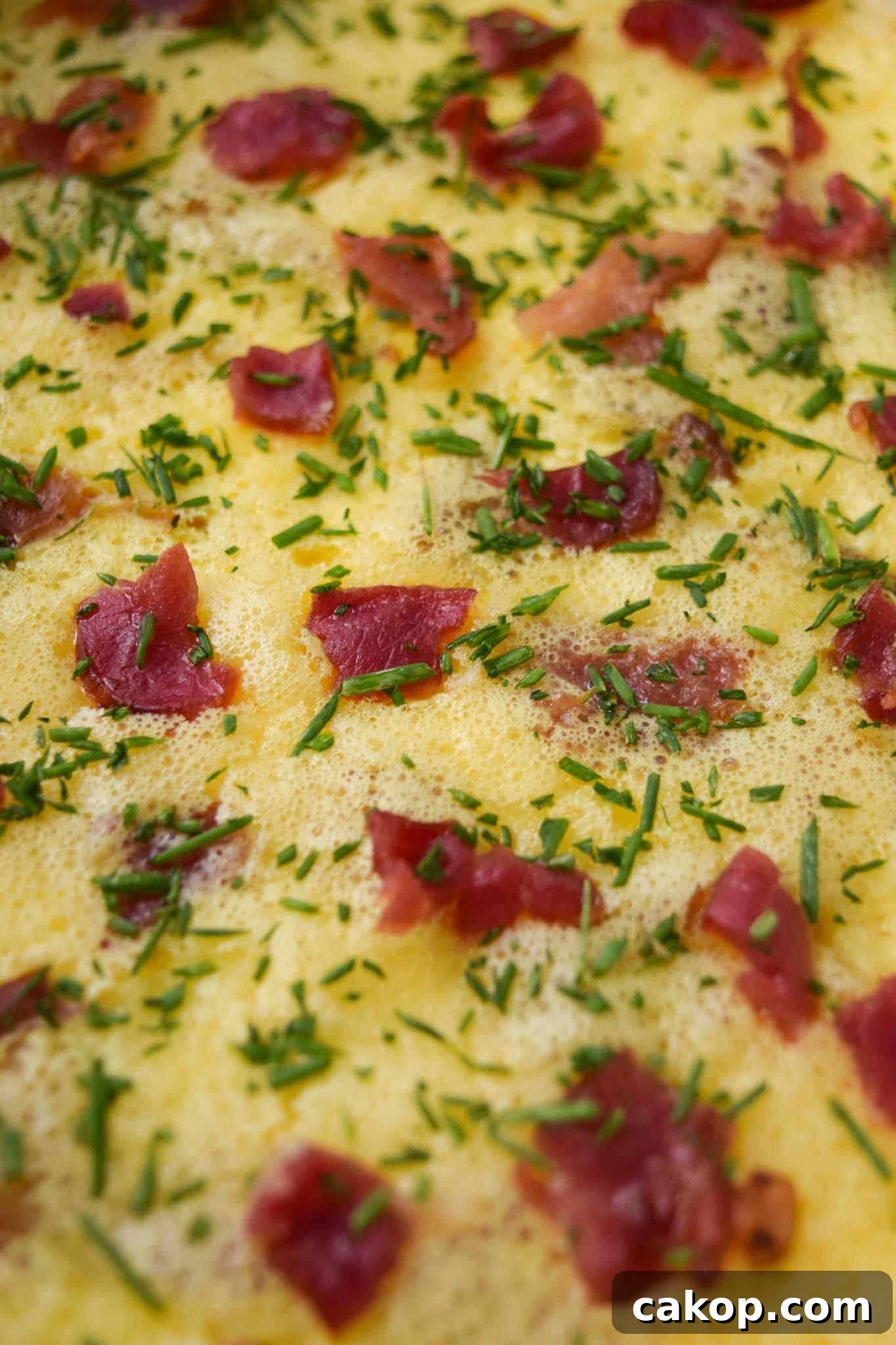 Bacon and Gruyere Breakfast Casserole topped with chives close up view