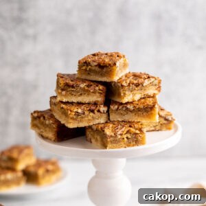 A cake stand filled with pecan bar squares.