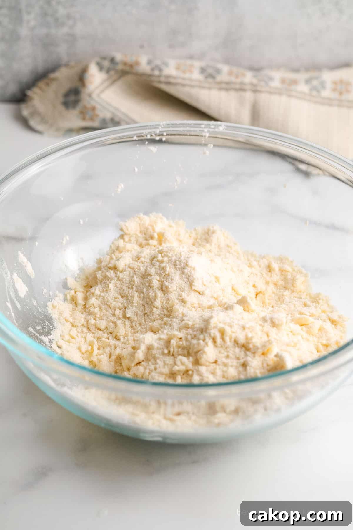Mixed shortbread dough in a glass bowl.