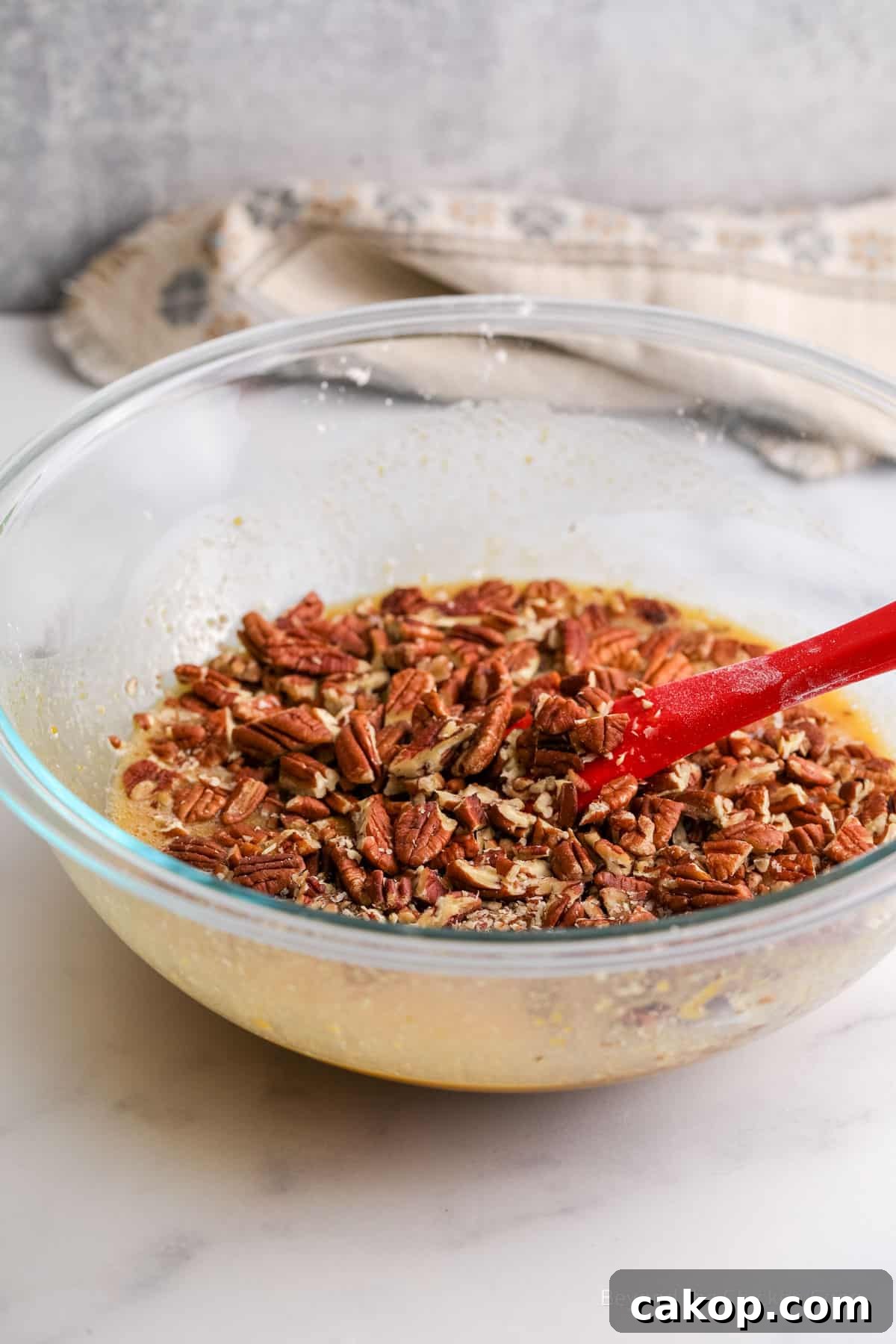 Adding pecans to a filing mixture.
