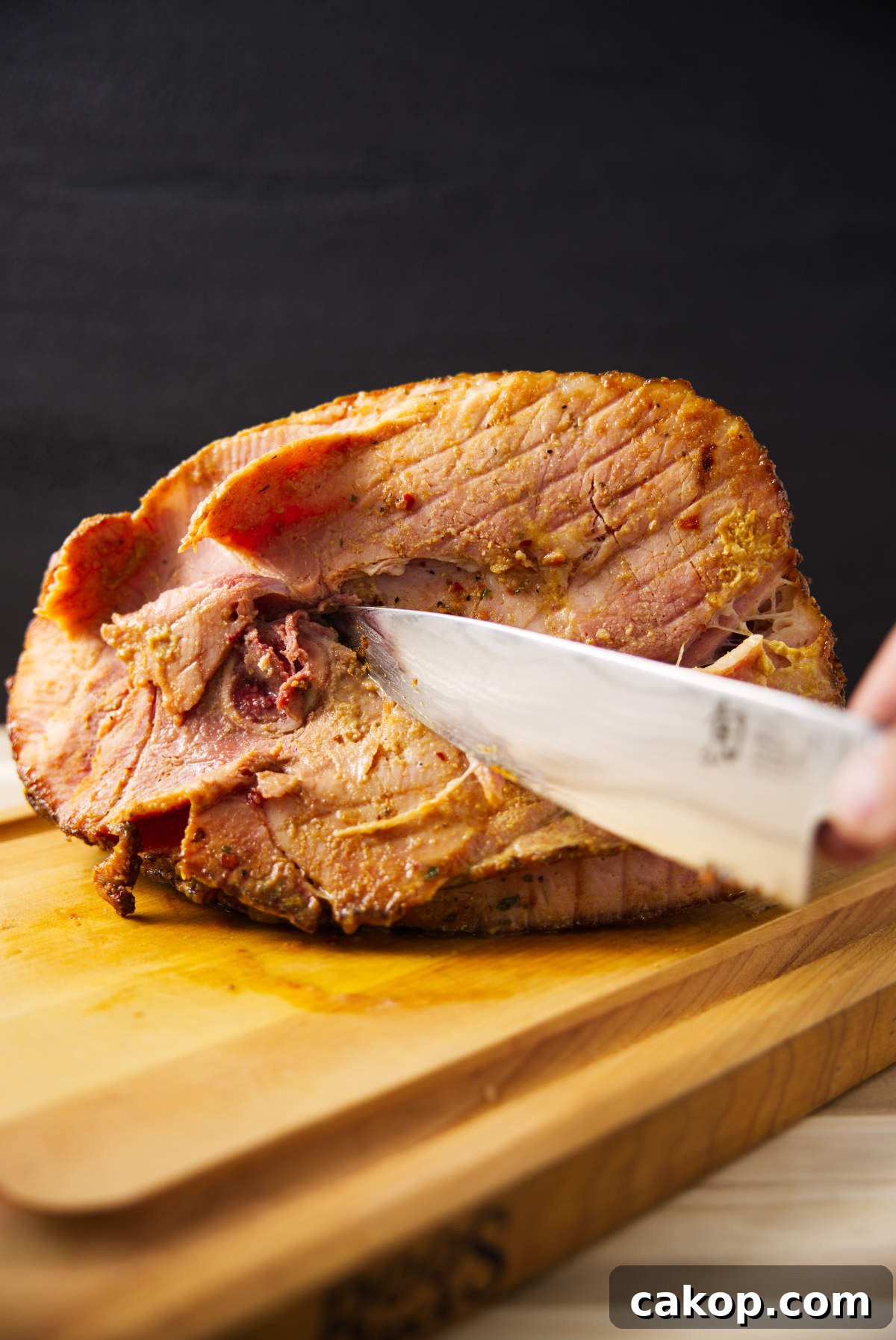 Double-Smoked Ham Recipe: How to Smoke Perfect Ham at Home 11 Cutting bone out of spiral sliced ham.
