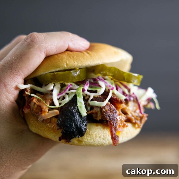 Double-Smoked Ham Recipe: How to Smoke Perfect Ham at Home 13 Pulled pork sandwich made from smoked pork butt (smoked pork shoulder). With pickles, slaw, and BBQ sauce.