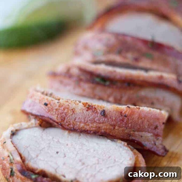 Double-Smoked Ham Recipe: How to Smoke Perfect Ham at Home 14 Bacon wrapped pork tenderloin cut into slices on wood cutting board with cilantro and lime garnish