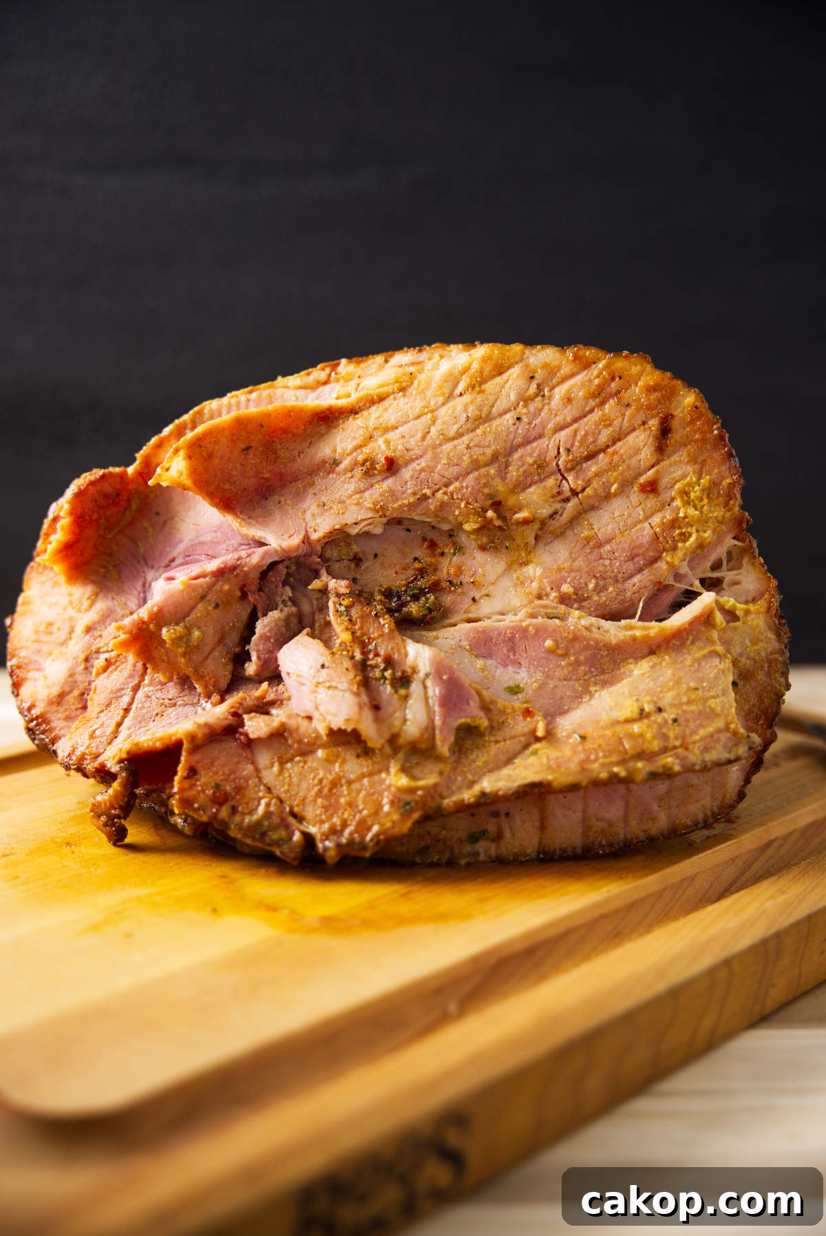 Double-Smoked Ham Recipe: How to Smoke Perfect Ham at Home 3 Spiral sliced twice smoked ham resting on butcher block.