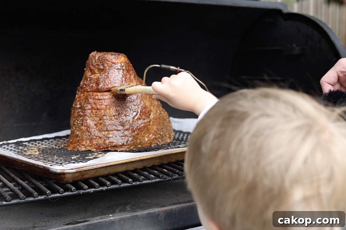 Double-Smoked Ham Recipe: How to Smoke Perfect Ham at Home 9 Brushing glaze on the ham while it is on the Traeger.