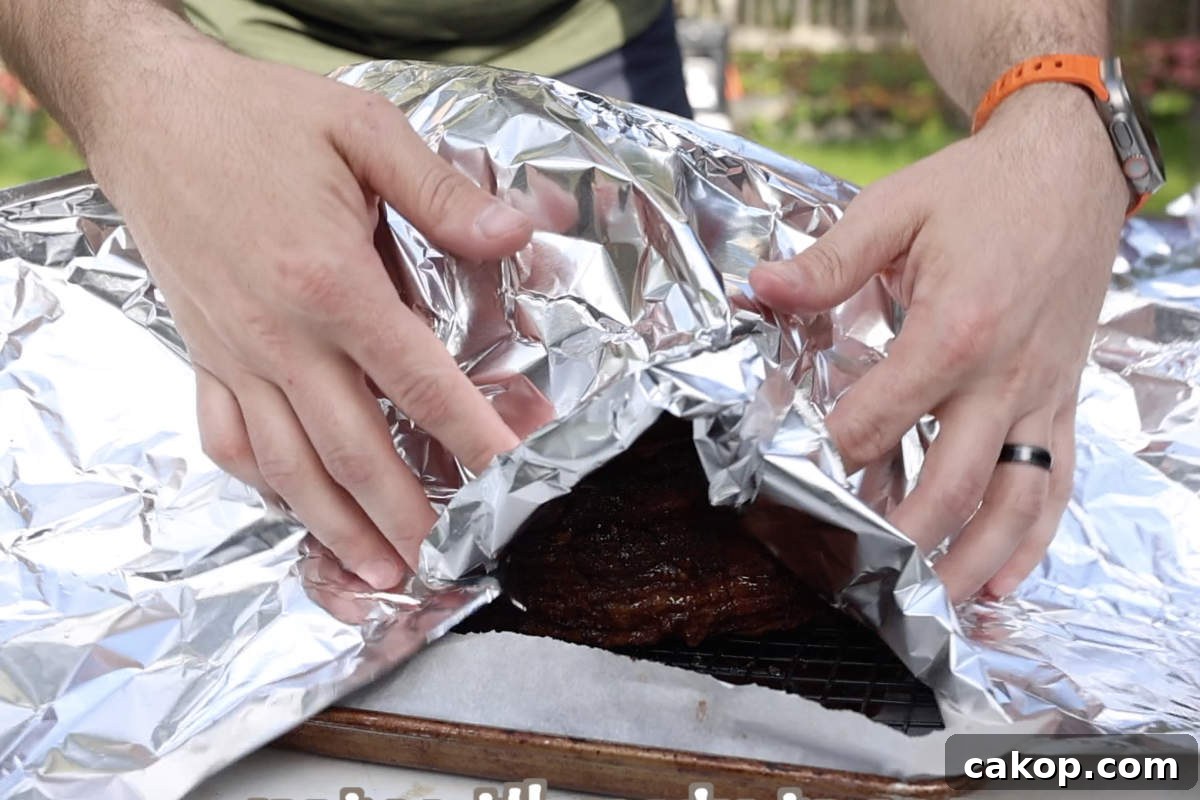 Double-Smoked Ham Recipe: How to Smoke Perfect Ham at Home 10 Putting foil over the double smoked ham before letting it rest.