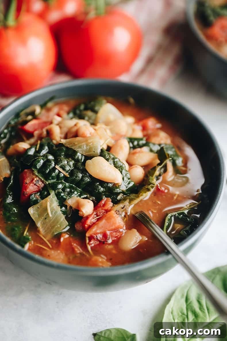 24 Comforting Vegetarian Soup Recipes for Every Season 2 tuscan white bean soup in a blue bowl.