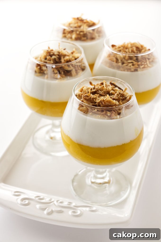 Coconut Mango Panna Cotta Recipe with Creamy Tropical Layered Dessert 5 Four servings of coconut-mango panna cotta garnished with toasted coconut