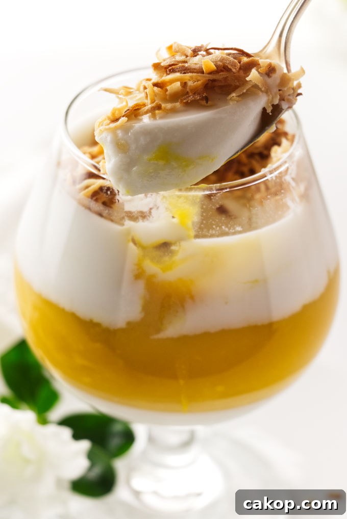 Coconut Mango Panna Cotta Recipe with Creamy Tropical Layered Dessert 6 A spoonful of coconut-mango panna cotta