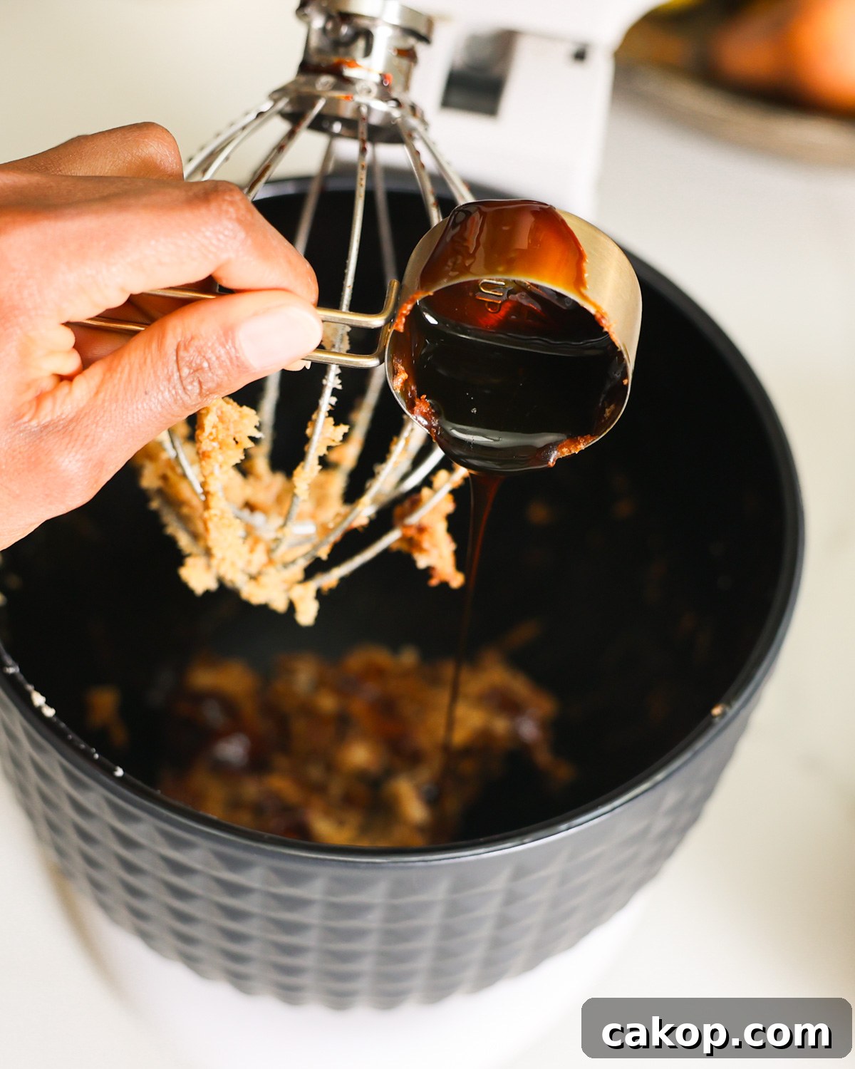 adding molasses to mixer
