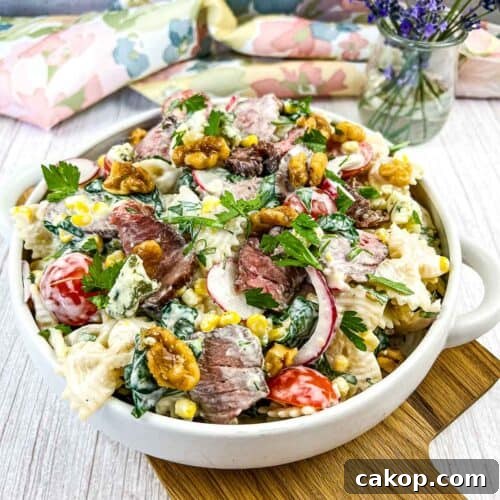 Steak and pasta salad in a white bowl
