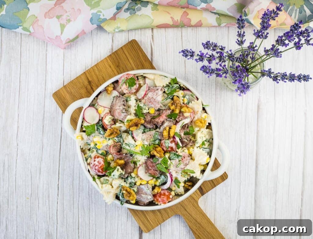 A top-down shot of Steak & Pasta Salad in a white bowl.