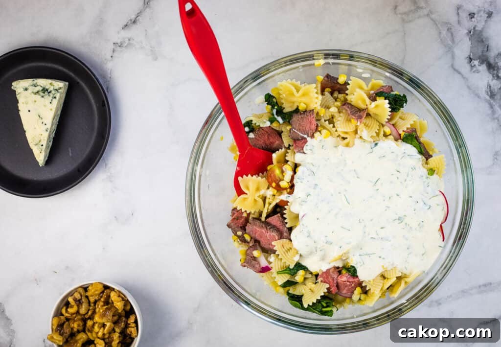 Dressing added to bowl of ingredients.