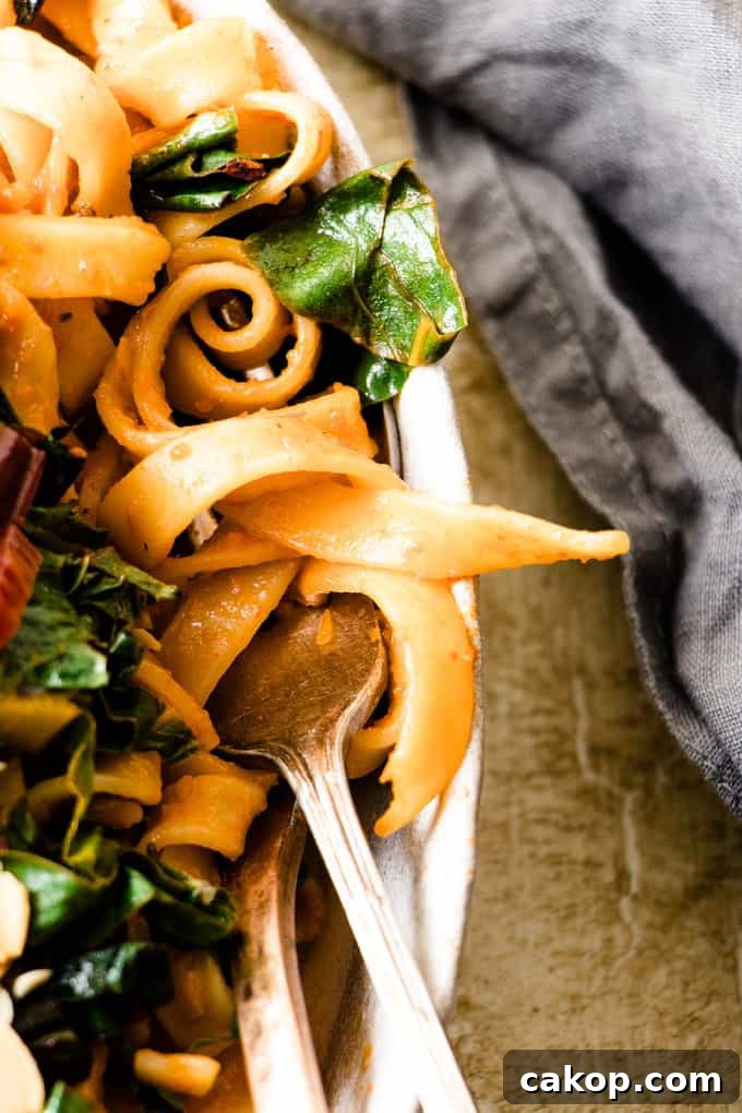 This tuscan pasta feast is a quick way to get extra veggies. Rich roasted red pepper pasta with bitter wilted Italian green and toasted almonds.