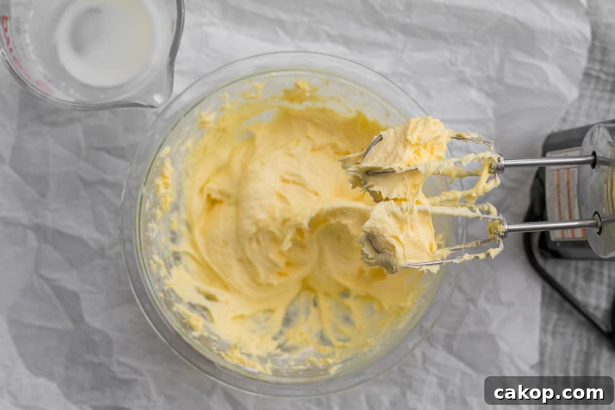 pudding being mixed in a glass bowl with heavy cream.
