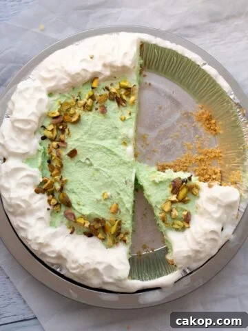 pistachio pudding pie that has been cut in it's pie tin