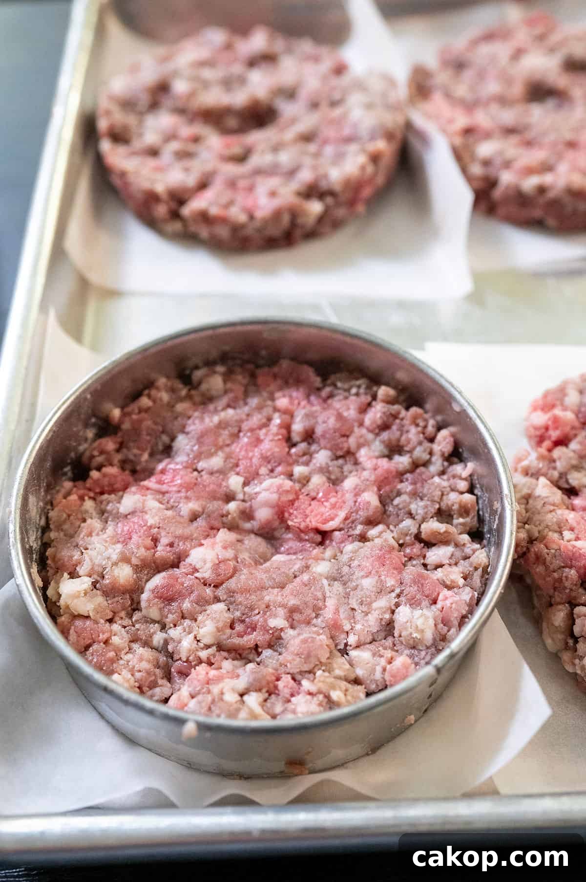 Reverse-Sear Smoked and Grilled Burgers for Juicy Results 5 shaping burger patties with cookie cutter.